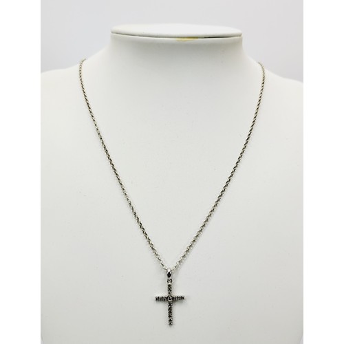 378 - A hallmarked 9ct white gold cross pendant set with diamonds together with a 925 silver chain, cross ... 