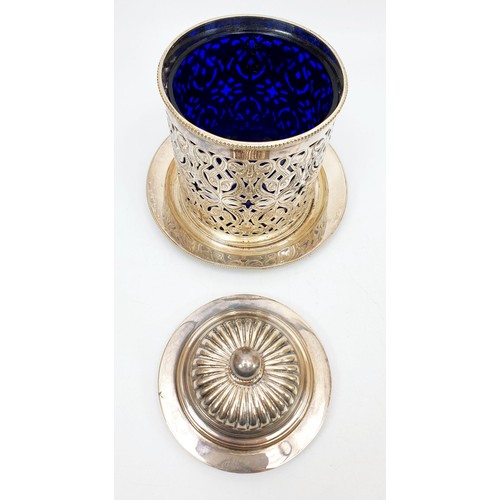 9 - A silver plated lidded pierce work canister with internal glass blue liner, height 5.5