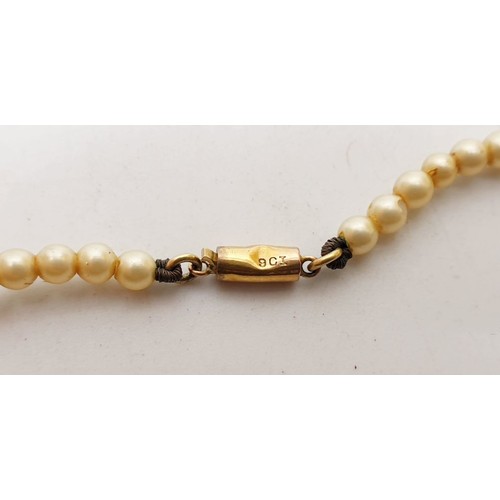 165 - A pearl necklace with a 9ct gold clasp. UK shipping £14.