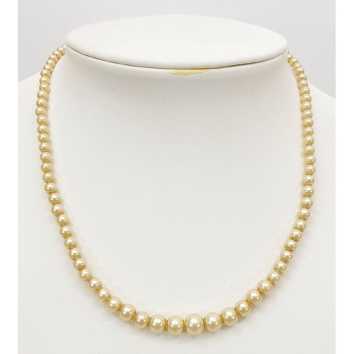 165 - A pearl necklace with a 9ct gold clasp. UK shipping £14.