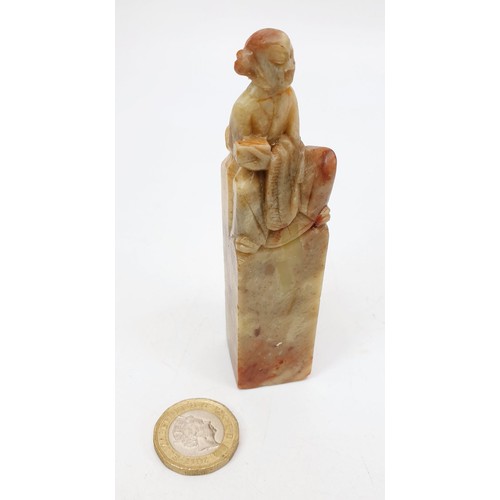 222 - A Chinese soap stone carving of an elder seated on a stone, height 4