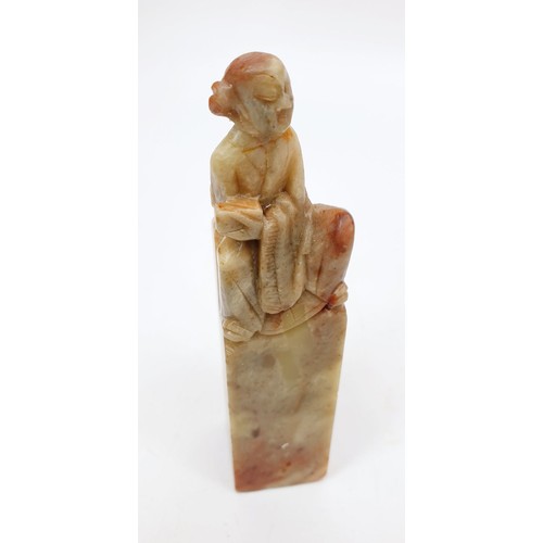 222 - A Chinese soap stone carving of an elder seated on a stone, height 4