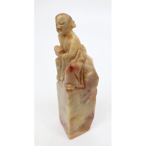 222 - A Chinese soap stone carving of an elder seated on a stone, height 4