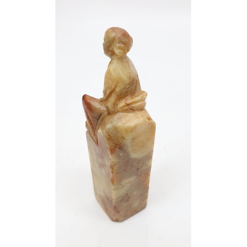 222 - A Chinese soap stone carving of an elder seated on a stone, height 4