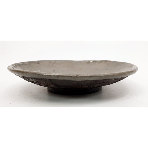 370 - An Chinese dish carved coconut shell dish with Buddhist motifs and lined with pewter, diameter 4.75