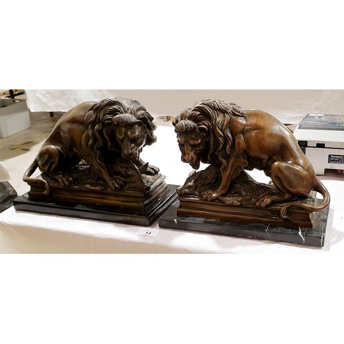 14 - A pair of cast brass reproduction lions, length 11.5