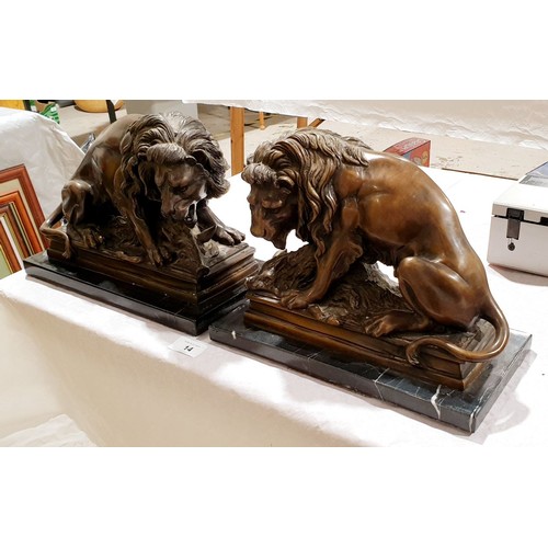 14 - A pair of cast brass reproduction lions, length 11.5