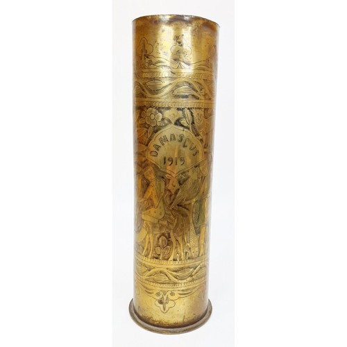 26 - A WWI German trench art shell case dated 1916, intricately decorated with figures, animals and folia... 