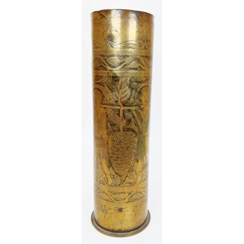 26 - A WWI German trench art shell case dated 1916, intricately decorated with figures, animals and folia... 