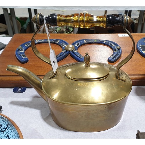 28 - An antique brass kettle with a glass handle, height 8.5