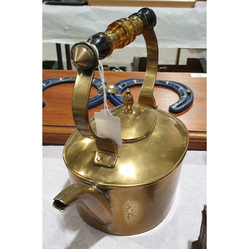 28 - An antique brass kettle with a glass handle, height 8.5