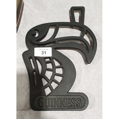 31 - A cast iron Guinness trivet, length 9.25