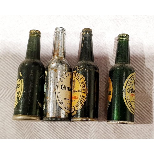 33 - Four vintage lighters in the form of Guinness bottles. UK shipping £14.