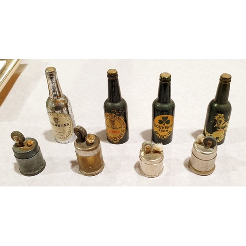 33 - Four vintage lighters in the form of Guinness bottles. UK shipping £14.