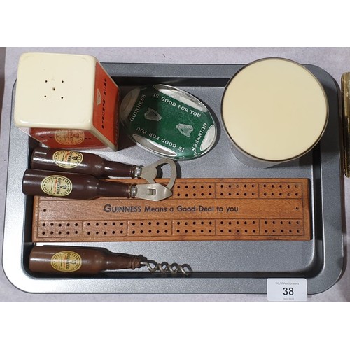 38 - A tray of vintage Guinness memorabilia including a bar top advertisement. UK shipping £14.