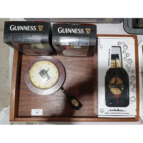 41 - Four Guinness clocks. UK shipping £14.