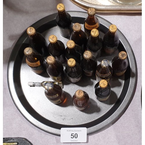 50 - Fifteen vintage miniature glass Guinness bottles and two Harp bottles. UK shipping £14.