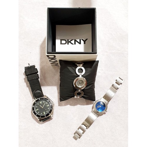 91 - A boxed DKNY ladies wrist watch, a Storm ladies wrist watch and a gentleman's dive watch, all in wor... 