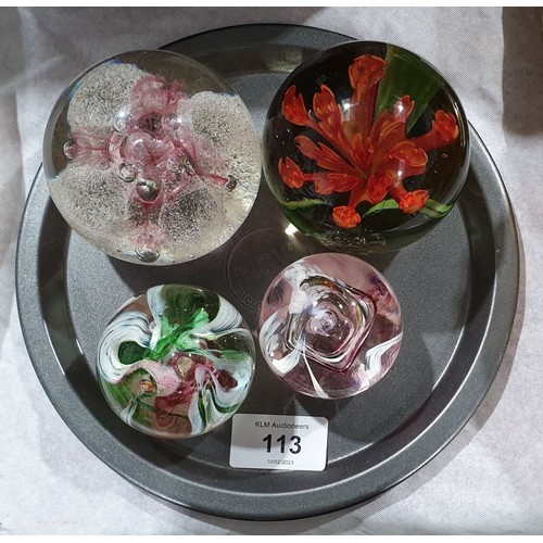 113 - Four paper weights including two Caithness. UK shipping £14.