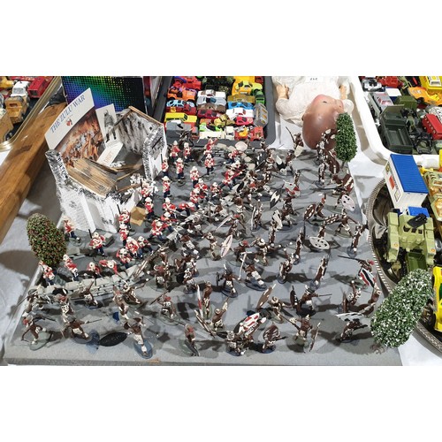 237 - A diorama depicting The Battle of Rorke's Drift with plastic soldiers and Zulu warriors, 20