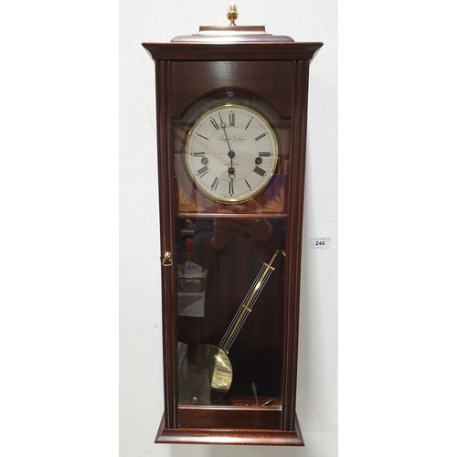 244 - A Knight & Gibbins mahogany wall clock, length 29