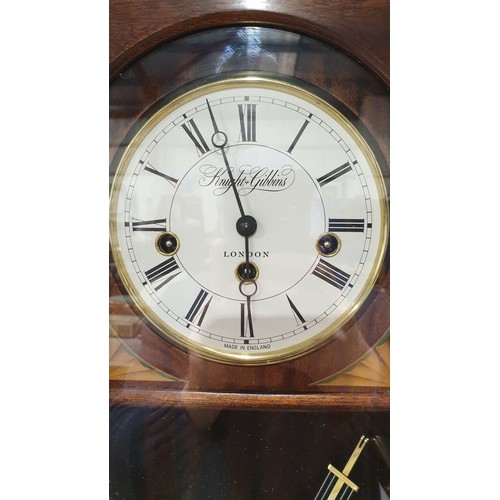 244 - A Knight & Gibbins mahogany wall clock, length 29