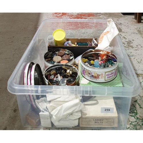 259 - A box of sewing items including tins of buttons. UK shipping £14.