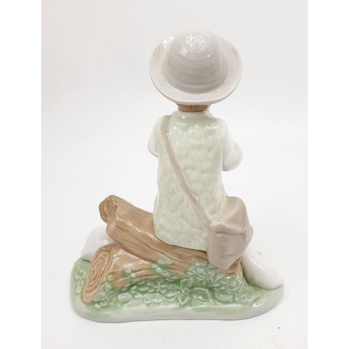 265 - A Nao figure of a boy with two sheep, height 7