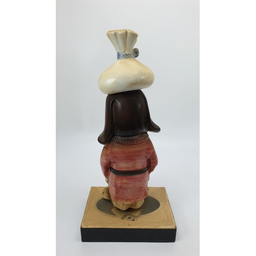 269 - A vintage novelty musical ceramic decanter in the form of a dog with a hangover, A/F, height 12