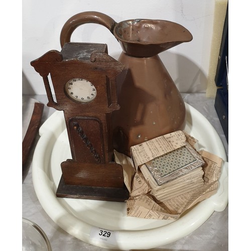 329 - A vintage oak moneybox in the form of a clock stamped Benn & Mitchell, Cabinet makers, Halifax, heig... 