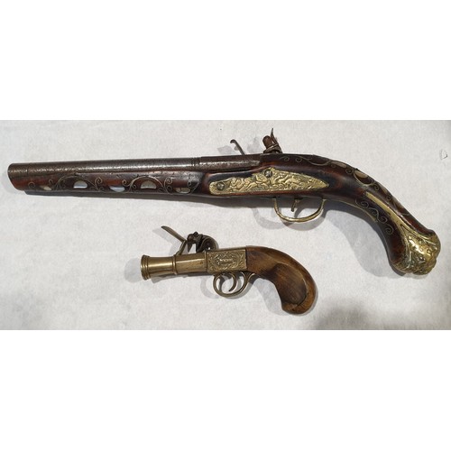 429 - An antique flintlock pistol inlaid with mother of pearl and white metal wire, length 17