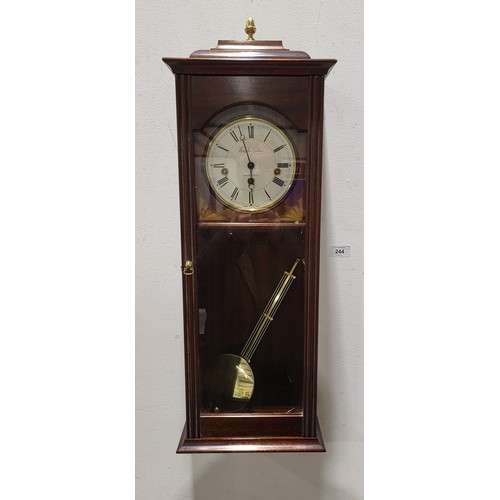 244 - A Knight & Gibbins mahogany wall clock, length 29