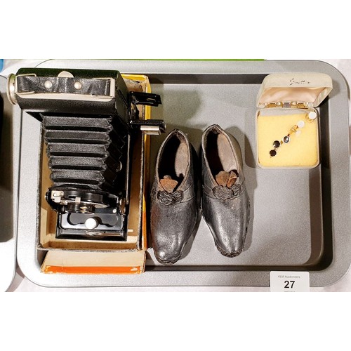 27 - A vintage Kodak SIX-20 folding Brownie, a pair of child's antique clogs and studs. UK shipping £14.