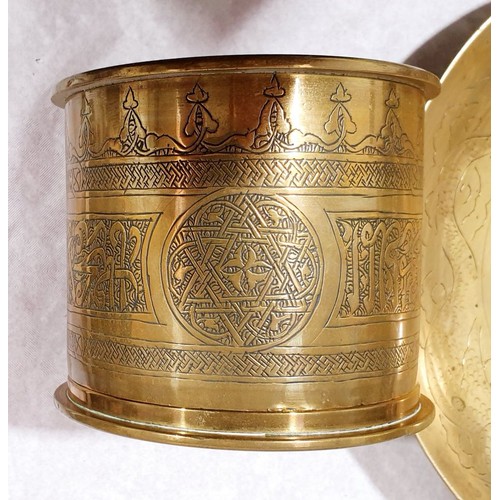 25 - A lidded canister made from brass shell casing dated 1912 and decorated in the Islamic style, height... 