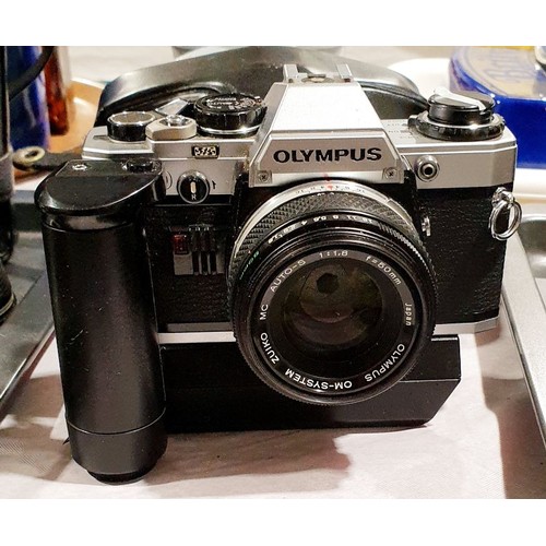 53 - An Olympus OM10 camera with an automatic winder. UK shipping £14.