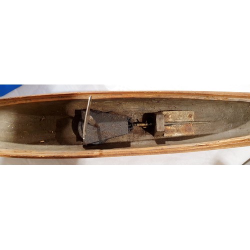 214 - A vintage clockwork model boat, length 23.75