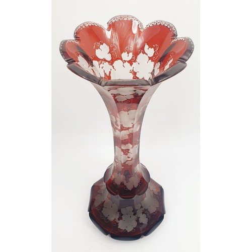 289 - An antique cranberry glass vase with etched grapes and vine leaves decoration, height 13.5