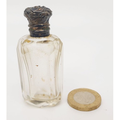 404 - A cut glass perfume bottle with white metal top and inner glass stopper, height 2.25