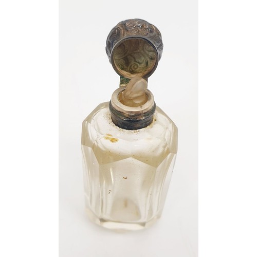 404 - A cut glass perfume bottle with white metal top and inner glass stopper, height 2.25