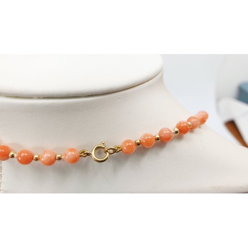 429 - A 9ct gold and pink hard stone bead necklace. UK shipping £14.