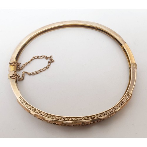 430 - A yellow metal bangle, weight 11g. UK shipping £14.