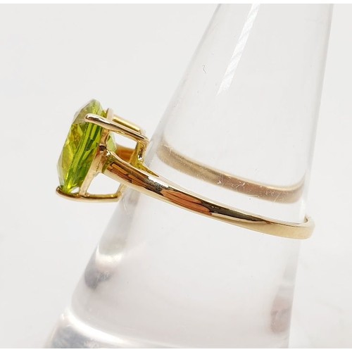 5 - A hallmarked 9ct gold ring set with a peridot, size N/O, gross weight 1.8g. UK shipping £14.