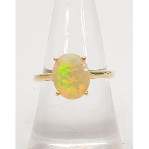 11 - A hallmarked 9ct gold ring set with an Ethiopian opal, size N/O, weight 2g. UK shipping £14.