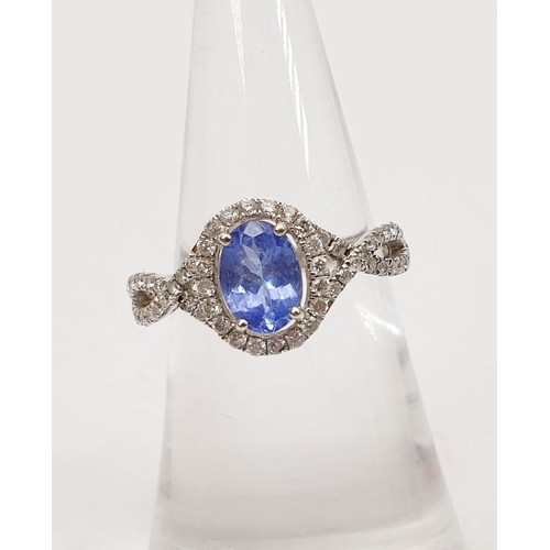 18 - A 14ct white gold ring by Sophia Fiori set with a blue stone and diamonds, size J/K, weight 2.5g. UK... 