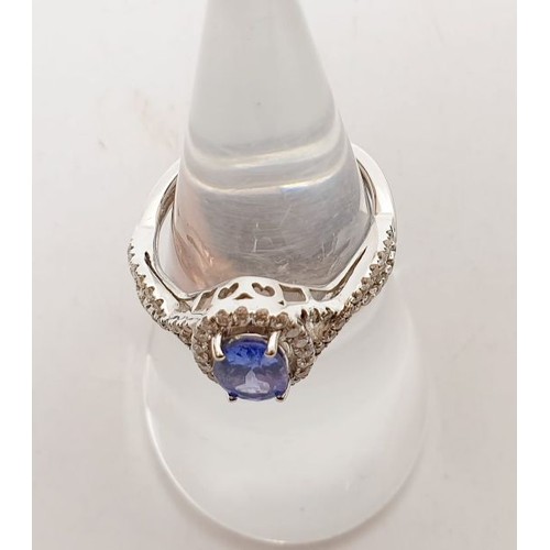 18 - A 14ct white gold ring by Sophia Fiori set with a blue stone and diamonds, size J/K, weight 2.5g. UK... 