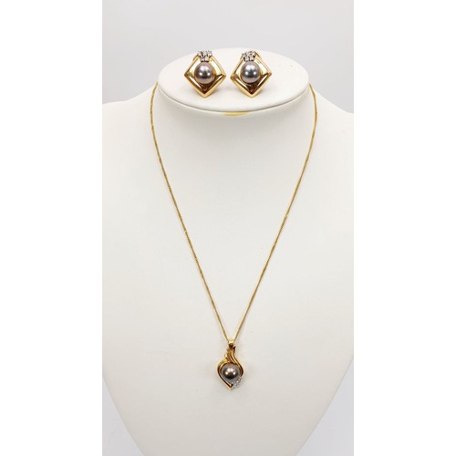 21 - An 18ct gold pendant set with a black pearl and diamonds on a 9ct gold chain together with matching ... 