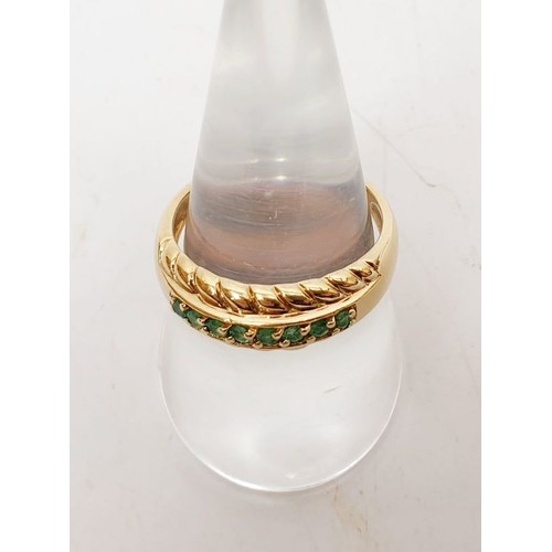 22 - A 9ct gold ring set with emeralds, size R/S, gross weight 3.5g. UK shipping £14.