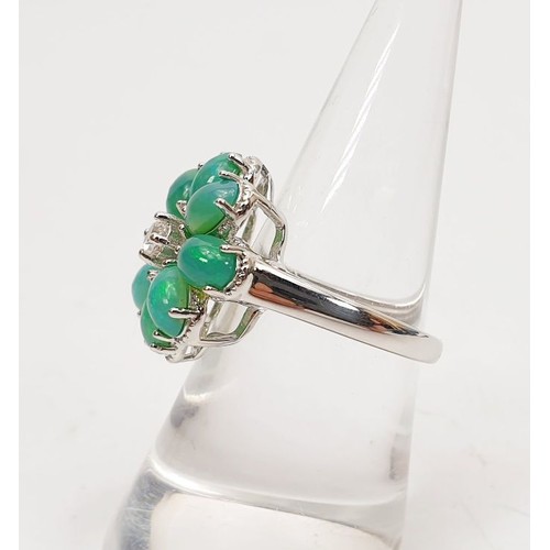 28 - A silver ring set with opals and topaz, size N/O.  UK shipping £14.