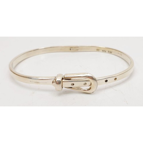 32 - A silver buckle bangle, weight 14g. UK shipping £14.