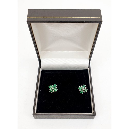 14 - A pair of 9ct white gold earrings set with emeralds and diamonds. UK shipping £14.